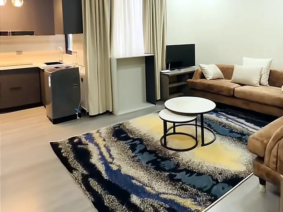 Living room with sofas, TV and open kitchen